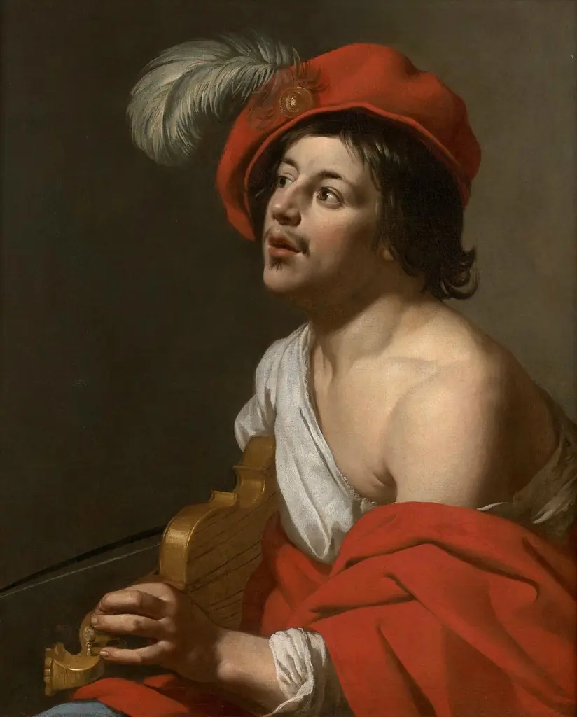 Young man tuning his violin