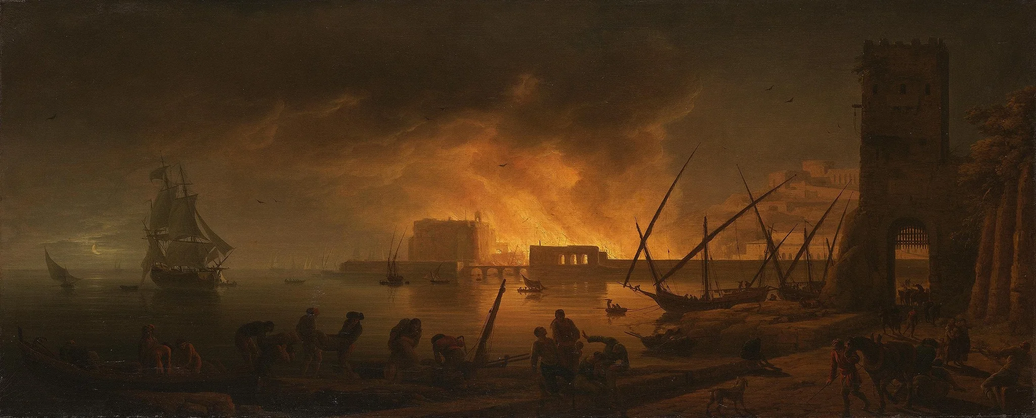 Fire in a marine harbor by night