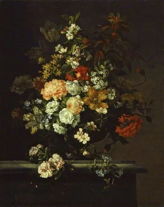 Still life of mixed flowers and a vase on a ledge