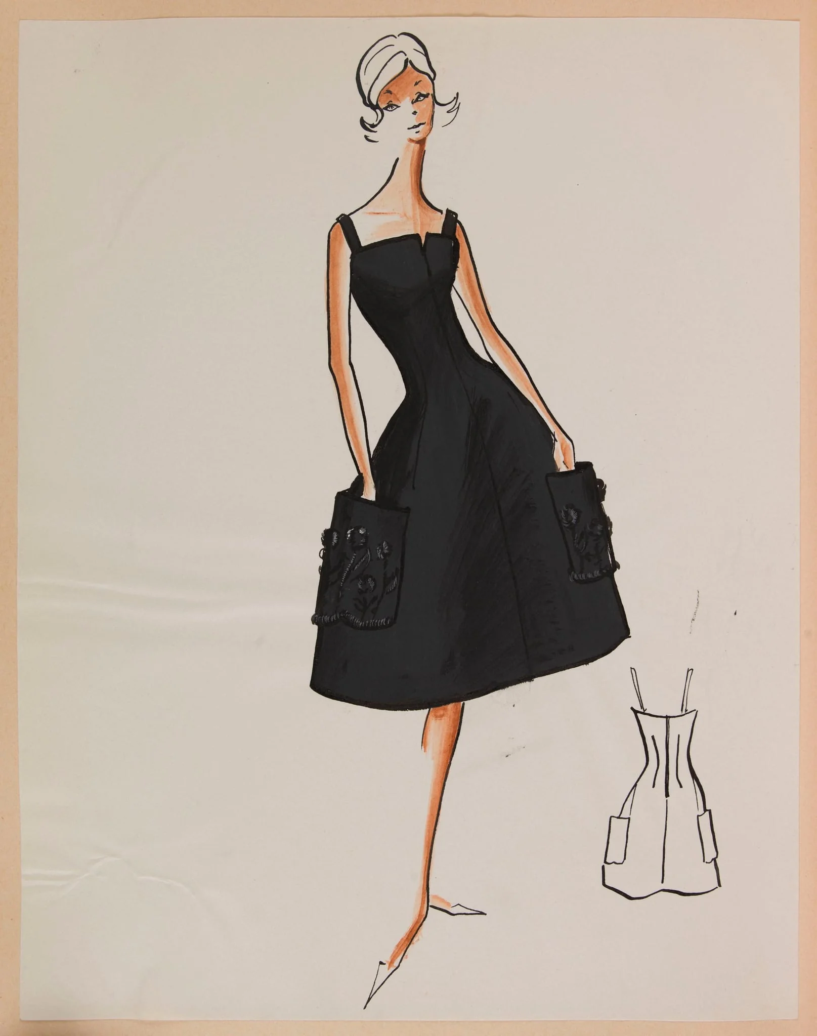 Robe noire à bretelles et deux larges poches brodées sur la jupe, by Marie-Louise Carven, 1959