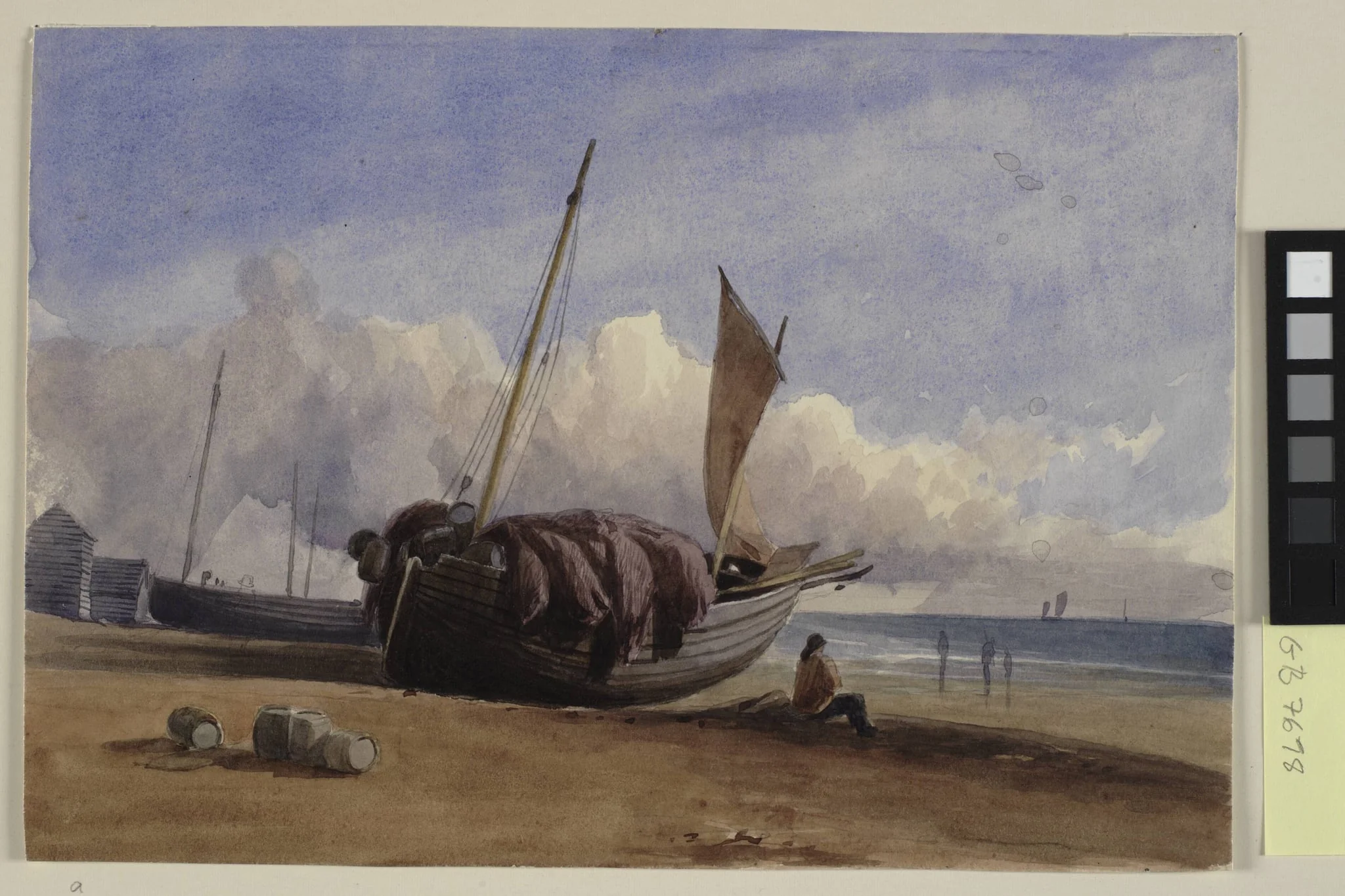 Beached fishing boat with seated fisherman