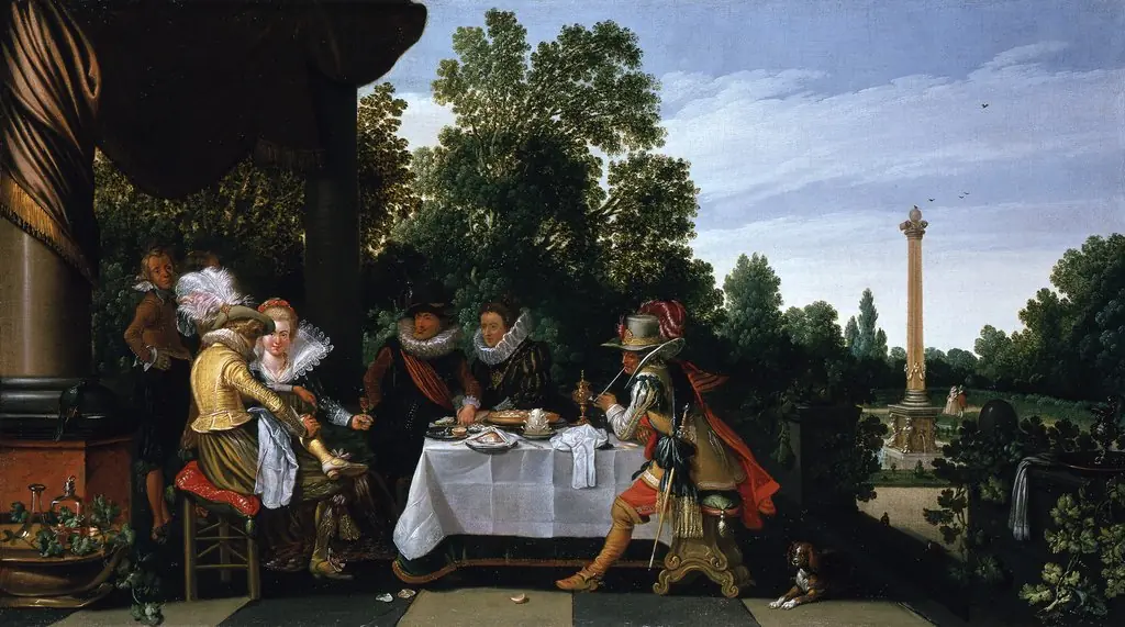 Elegant company eating, drinking, smoking and in conversation on a terrace