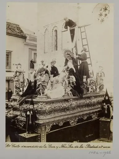 Processional statuary group belonging to the Fraternity of the Parish of Santa Marina, Seville, with children in special dress in the foreground
