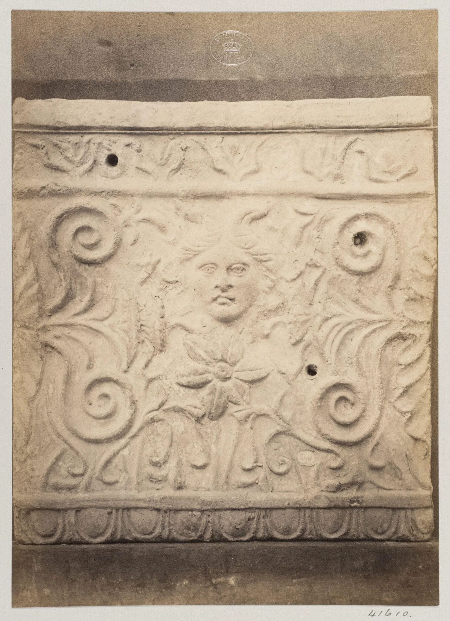 Bas-relief portion of a frieze with a mask in terra cotta