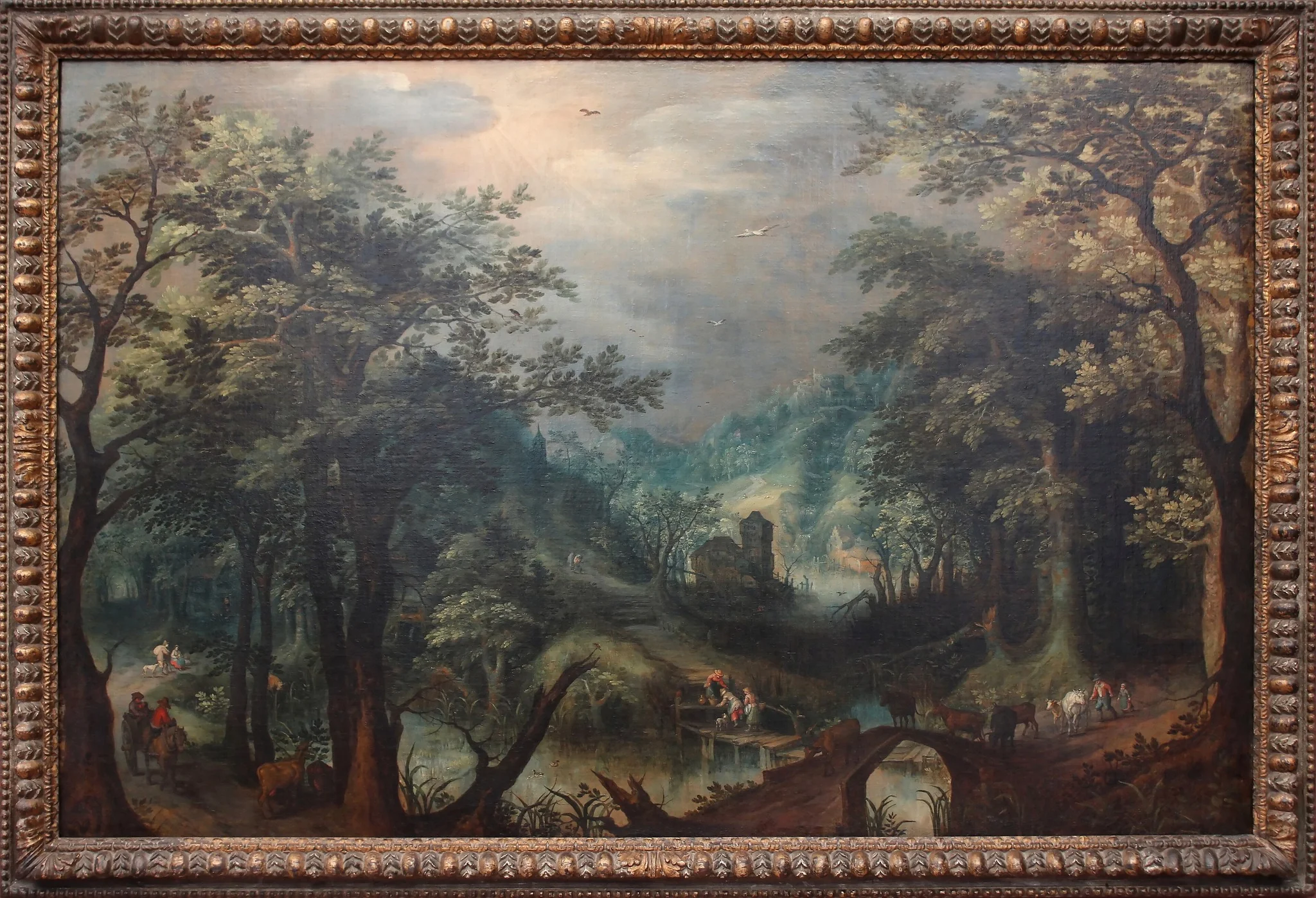 Wooded landscape with a river and cows on a bridge