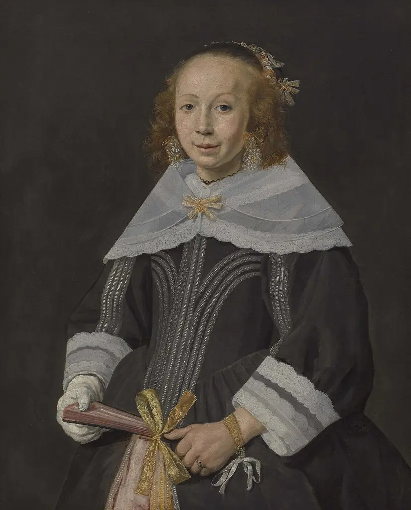 Portrait of a young woman holding a fan
