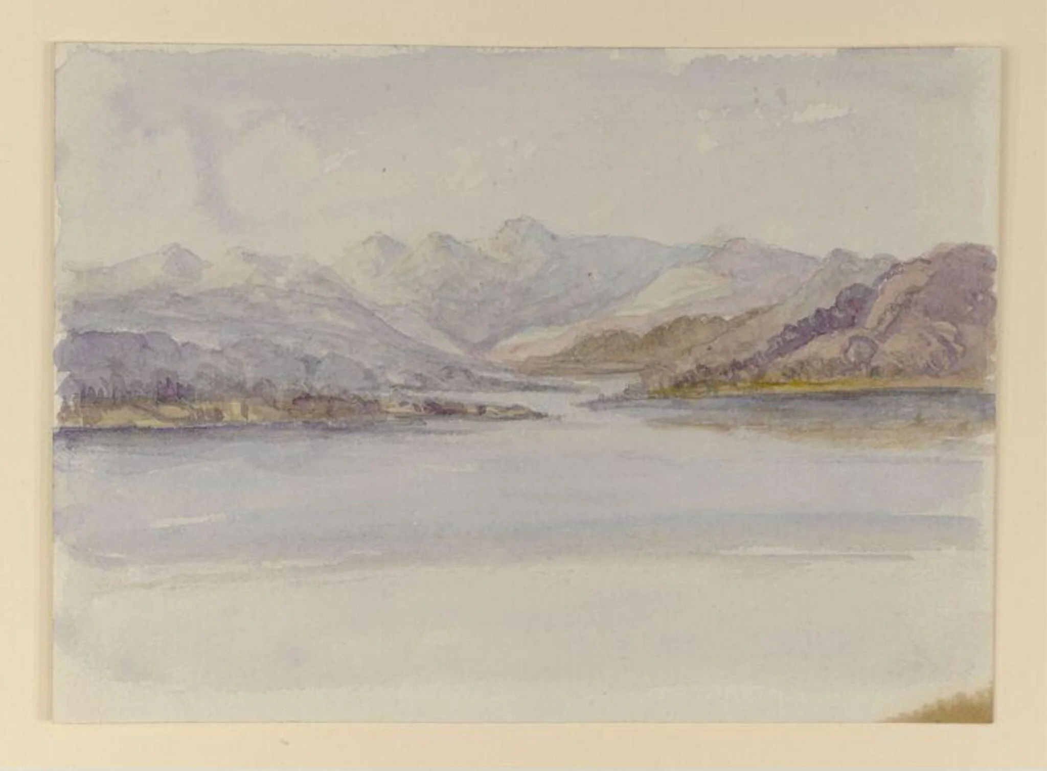 View across a lake to the Langdale Pikes