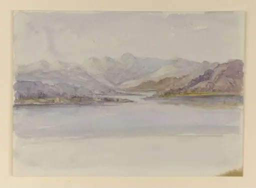 View across a lake to the Langdale Pikes