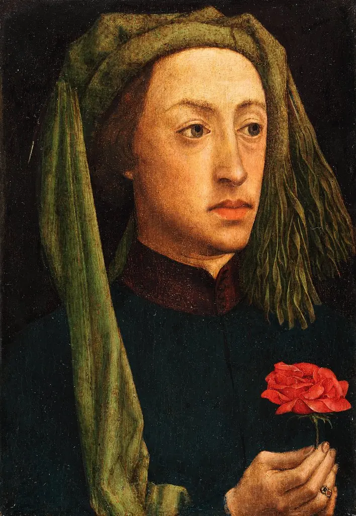 Portrait of a young man holding a red rose