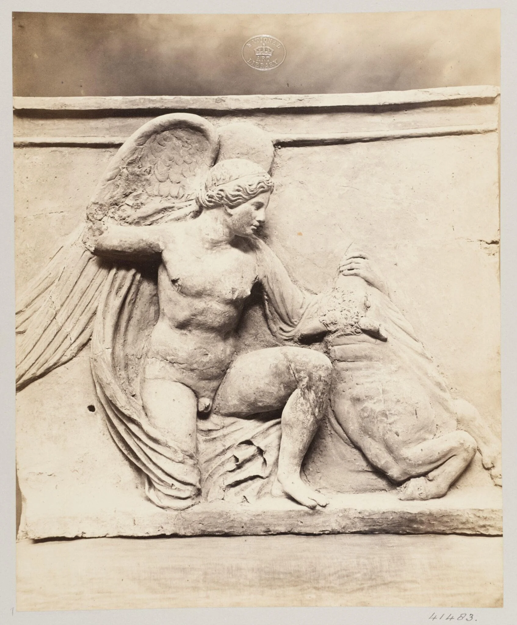 Winged figure slaying a bull in terra cotta
